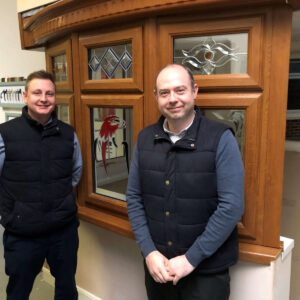 Matt and Dan standing in front of the 'Falcon' window at the showroom